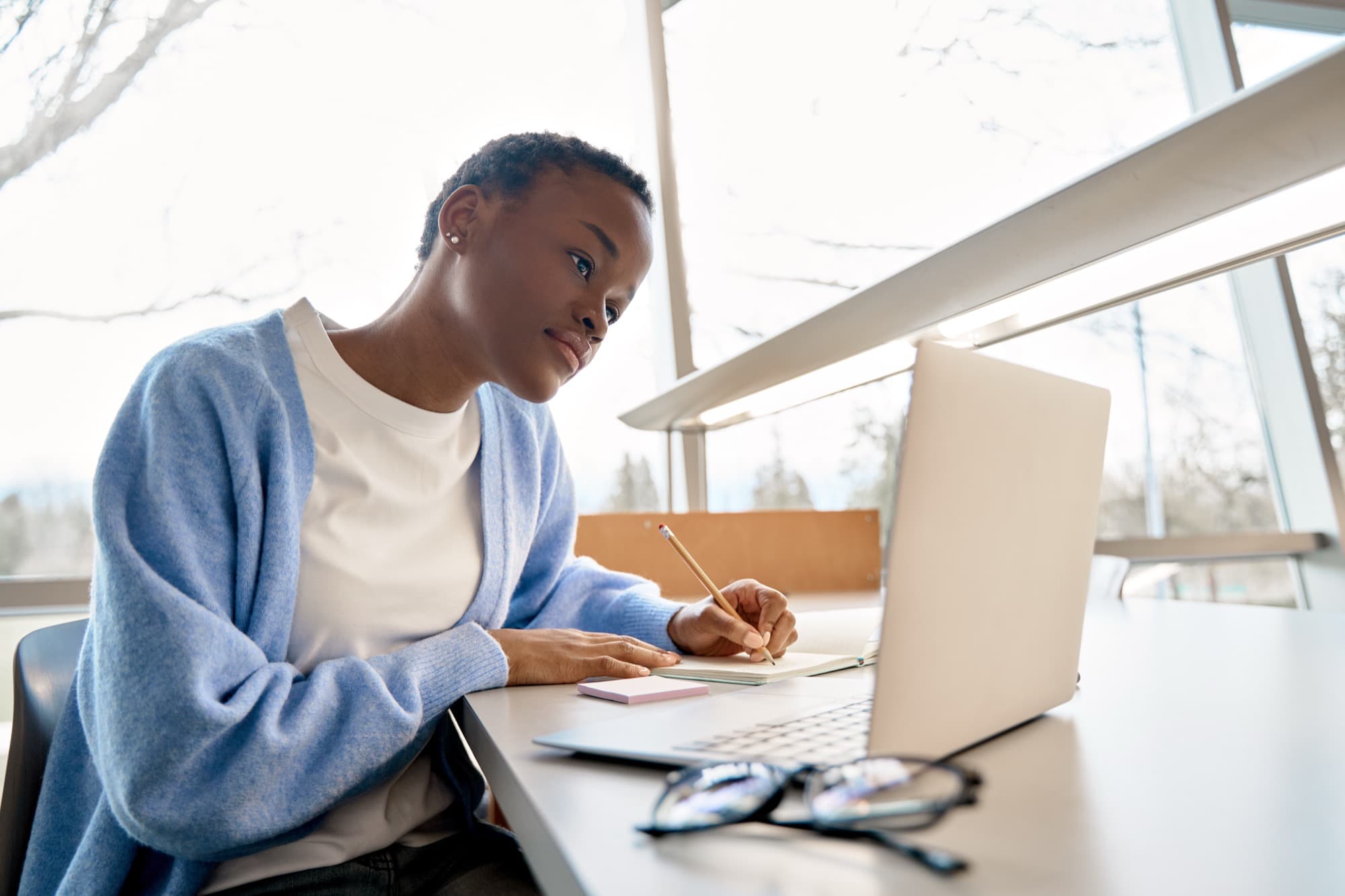 Candidate taking the Cambridge pre-test on a laptop